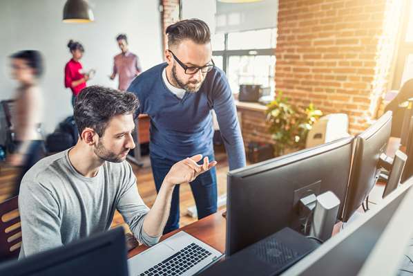 Software developers looking at computer screens