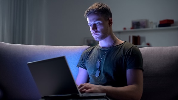 Serviceman searching for a job on laptop