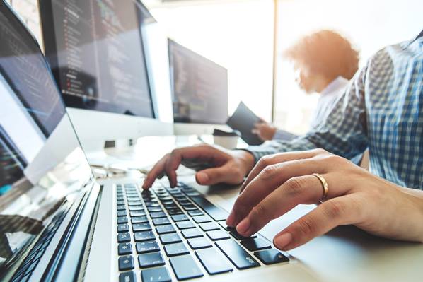 Software developer at work on his computer