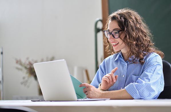 Student writing notes on her laptop