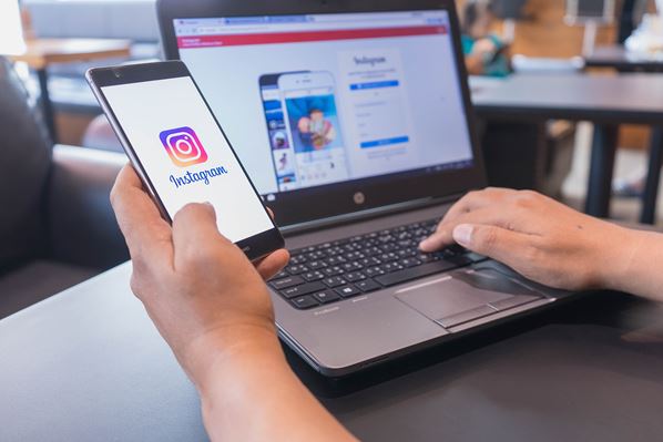 Instagram user on mobile and laptop