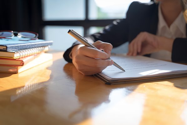 manager writing an employment contract