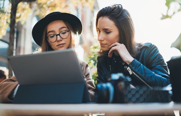 Two customers reading online reviews