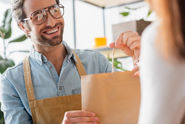 Green store owner serving customer