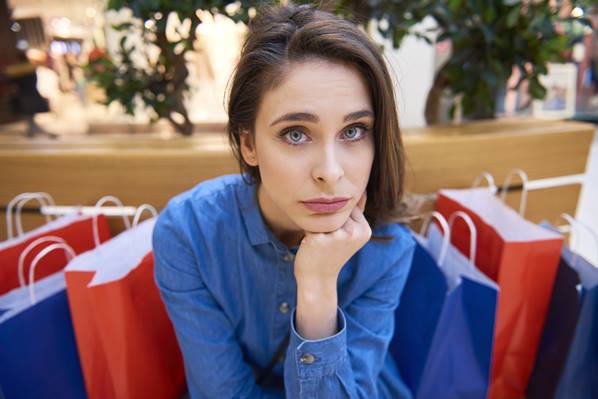 Upset customer with shopping bags
