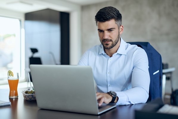 Man playing at gaming sites on his laptop