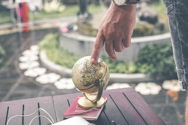 Finger on globe