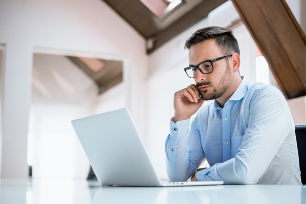 Manager creating a training course on his laptop