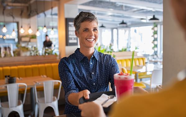 Waitress serving customer with a smile