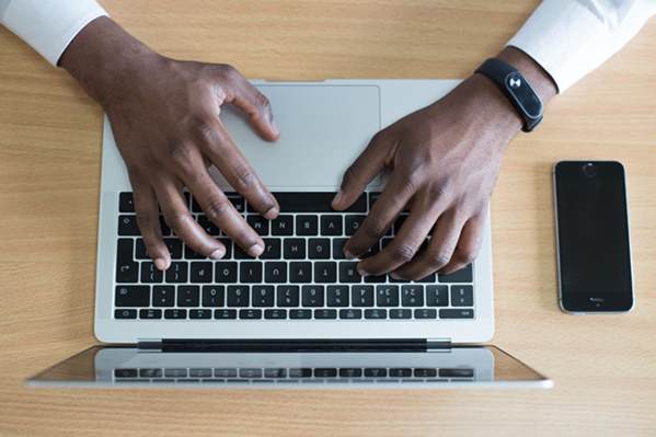 Man writing a complaint letter on his laptop
